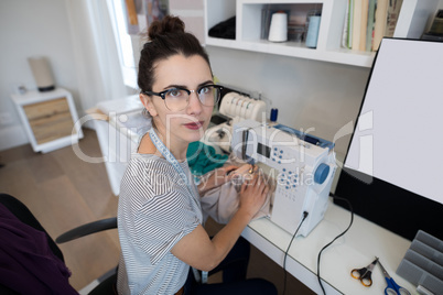 Fashion designer using sewing machine