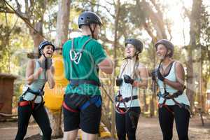 Coach interacting with trainee while wearing protective helmet