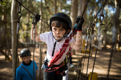 Determined boy crossing zip line