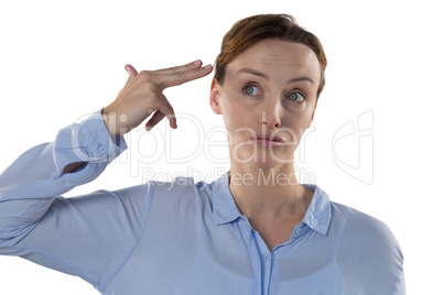 Female executive making gun gesture