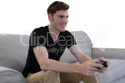 Man playing video game against white background Man playing video game against white background