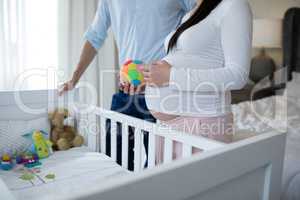 Couple holding toys in bedroom