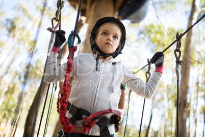 Determined girl crossing zip line