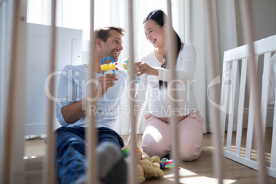 Happy couple playing with toys