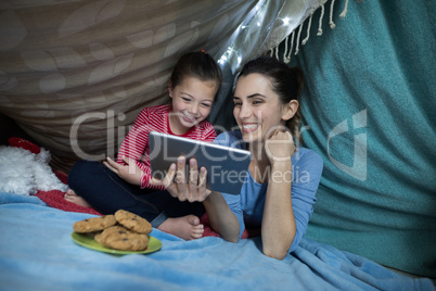 Mother and daughter using digital tablet