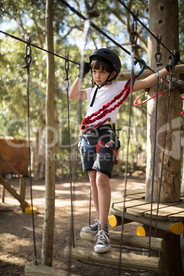 Determined boy crossing zip line