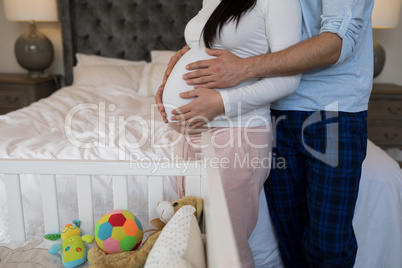 Man and woman feeling the presence of baby