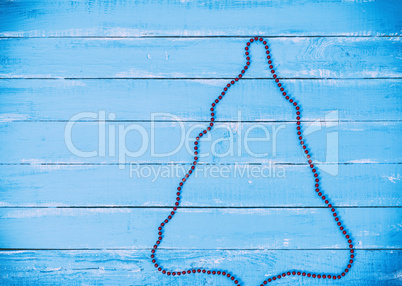 abstract blue wooden background with outline of a Christmas tree