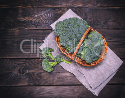 fresh cabbage broccoli in a brown wicker basket