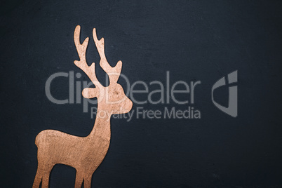 wooden carved deer on a black background