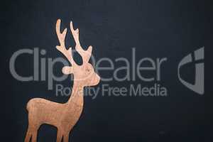 wooden carved deer on a black background