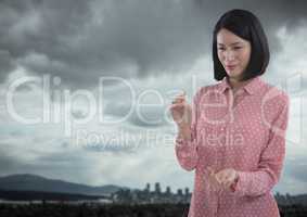 Businesswoman with hands palm open in city landscape