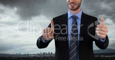 Businessman with hands touching air in city office
