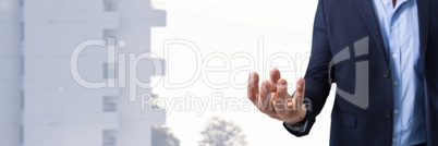 Businessman with hand palm open in city