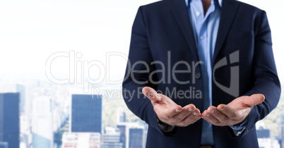 Businessman with hands palm open in city