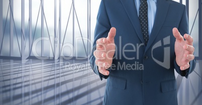 Businessman with hands palm open in city office