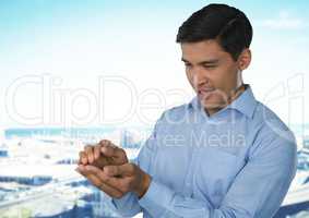 Businessman with hands palm together in city