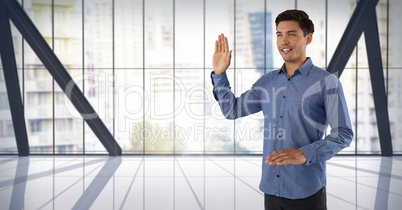 Businessman swearing honesty with hand in city office