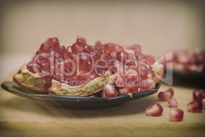 Grains of pomegranate fruit on the plate.