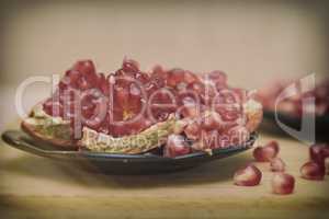 Grains of pomegranate fruit on the plate.