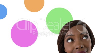Woman looking up with colorful circles