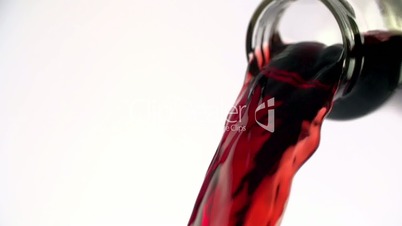 Colored liquid pouring in to the glass