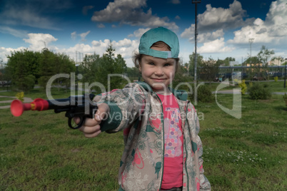 a little girl with a toy gun