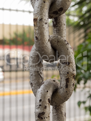 Close up of rusty chain links in the foreground