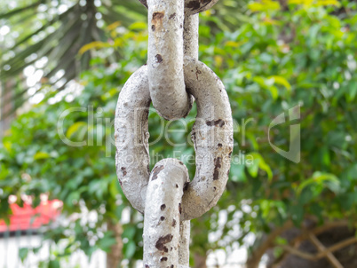 Close up of rusty chain links in the foreground