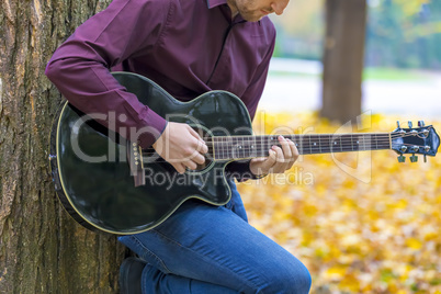 Close up person man's hands playing acoustic guitar artist music