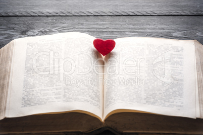 Red heart on an open book