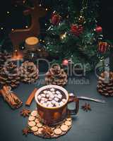 hot chocolate with marshmallows in a brown mug on a black backgr