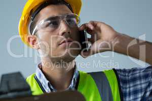 Male architect talking on mobile phone