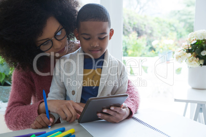 Mother and son using digital tablet