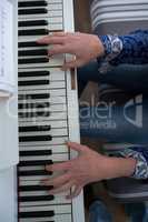 Mid section woman playing piano