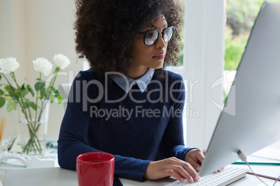 Beautiful woman working on desktop pc at desk