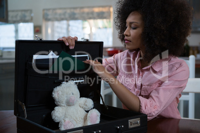 Woman checking briefcase at home