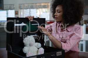 Woman checking briefcase at home