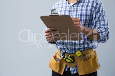 Male architect looking at clipboard