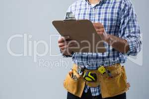 Male architect looking at clipboard