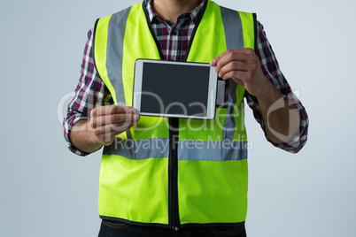 Male architect showing digital tablet against white background