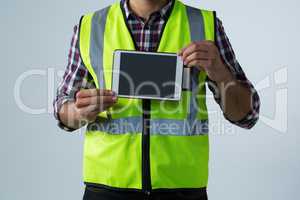 Male architect showing digital tablet against white background