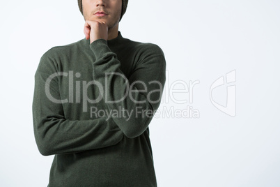 Thoughtful man standing against white background