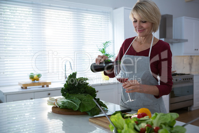 Beautiful woman having red wine at table