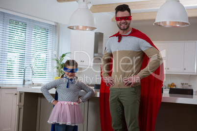 Portrait of father and daughter pretending to be superhero