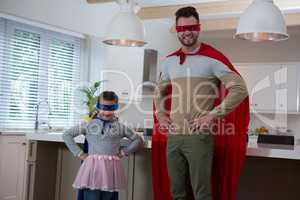 Portrait of father and daughter pretending to be superhero