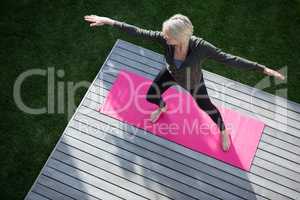 Overhead of woman practicing yoga in porch