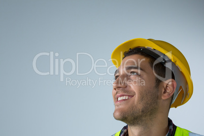 Male architect looking away against white background