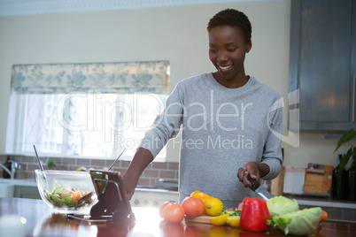 Beautiful woman using digital tablet in kitchen