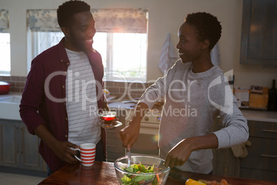 Couple preparing salad in the kitchen